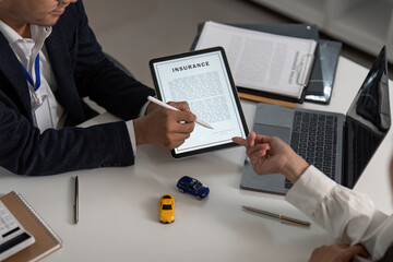 Insurance Consultation. Professional explaining policy details with digital tablet.