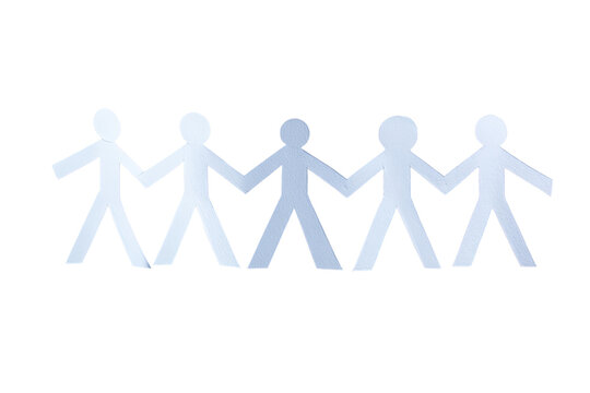 Silhouette of paper cut-out figures holding hands