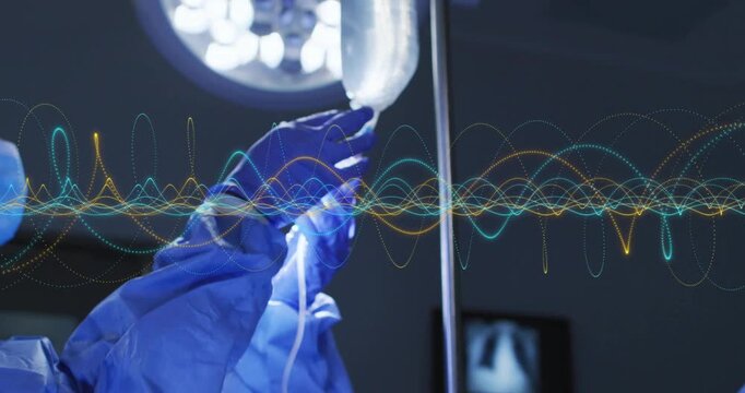 Anesthesiologist ventilating with bag-valve mask after nurse regulating IV flow to stabilize vitals