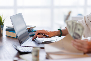 Asian male accountant or banker making money calculations. business man in workplace, Documents, tax, report for analysis Savings, finances and economy concept.
