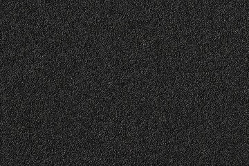 Close-up of black textured surface with fine grainy details
