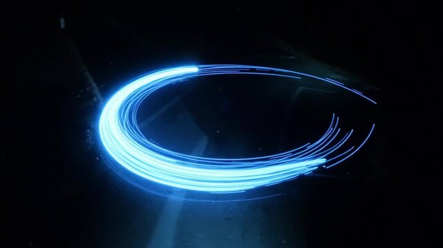 curved motion streak with blue trail and glowing line across the dark road as the laser be
