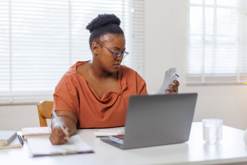 Fototapeta premium Unhappy woman feeling stressed calculating monthly expenses at home, facing financial problems or lack of money for utility household or rental payments, bankruptcy concept. 