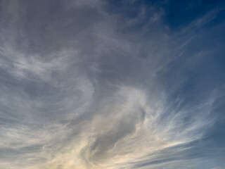 Cirrus clouds pattern on the blue sky.