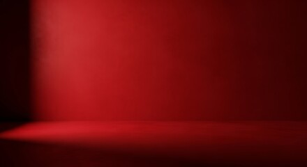 Obraz premium A minimalist red room with a dark corner and a bright spotlight illuminating the wall, creating a sense of depth and mystery