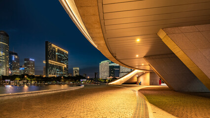 Modern cityscape at night with architectural structure and illuminated buildings
