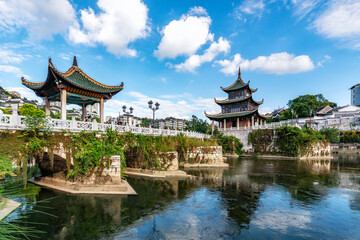 Traditional Chinese pavilions and pagodas by a serene body of water