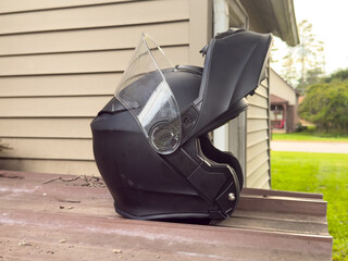 A black motorcycle helmet with a lifted visor