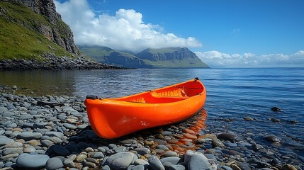 Orange kayak on rocky beach, scenic ocean view.
