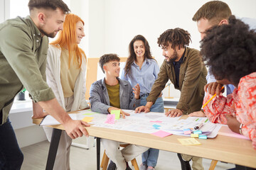 Diverse group of young business people company employees in casual clothes discussing job projects talking in office making great decisions with brainstorming. Coworkers working together at workplace