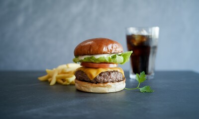 Cheeseburger, French Fries, and Soda Delicious Fast Food Meal Photograph