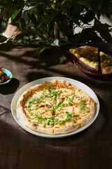 Pear and gorgonzola pizza with pine nuts, bright natural lighting, overhead composition