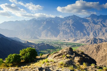 Fototapeta premium Cultivated valley with distant rocky peaks 