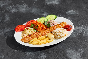 Lule kebab plated with vegetables and rice, bright lighting, overhead composition