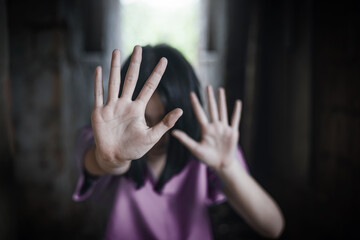 A woman raising her hands to stop violence against women and trafficking children. Abuse concept.