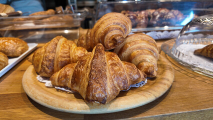 Freshly baked croissants on display at a bakery