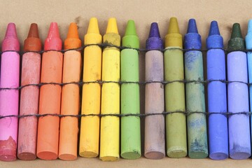 Well-used crayons in rainbow order, bound together