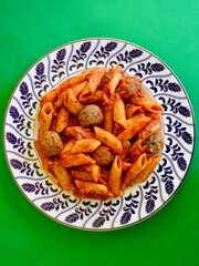 Italian meatballs with penne pasta in a delicious Napoli sauce.