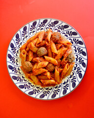 Italian meatballs with penne pasta in a delicious Napoli sauce.