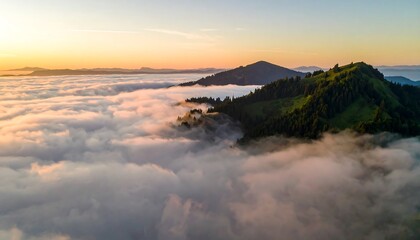 Fototapeta premium Sunrise over a mountain range shrouded in clouds (1)