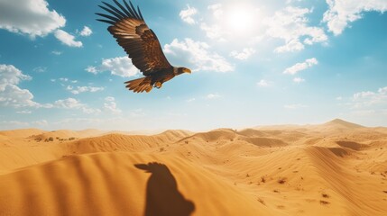 Eagle soars above the vast desert landscape under a bright sunny sky with scattered clouds above the sand dunes