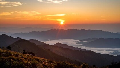 Sun dips behind mountains