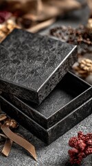 Open black gift box on gray stone, surrounded by fall decor