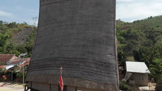 Ascending drone footage along a traditional Bahnar community house in Kon Tum province, Vietnam