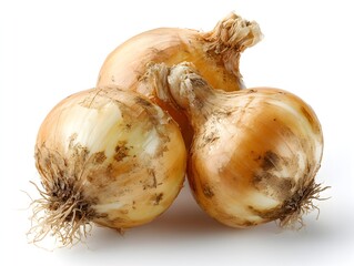 Three unpeeled yellow onions sit together with roots visible on a bright white background in natural light.