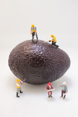 Miniature Workers Performing Construction On Giant Avocado
