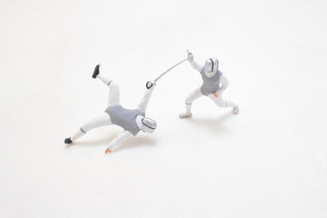 Competitive Fencing Match Between Two Athletes in Protective Gear