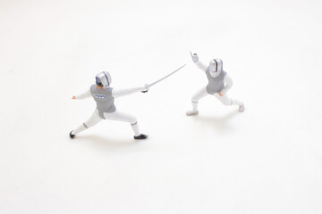 Competitive Fencing Match Between Two Athletes in Protective Gear