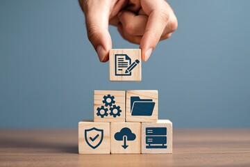 Person stacking wooden blocks with icons representing data management security and technology