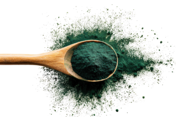 Wooden spoon filled with dark green powder, surrounded by a scattering of light powder