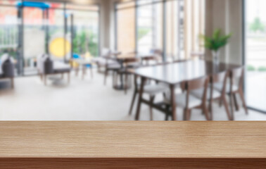 Empty wooden tabletop with blurred modern cafe background