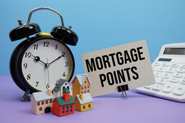 Mortgage Points phrase with Calculator, alarm clock, Model Houses Real Estate Financial Concept