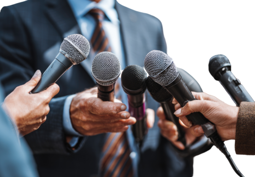 Press conference microphones.  Hands of reporters holding microphones angled towards a person in a suit