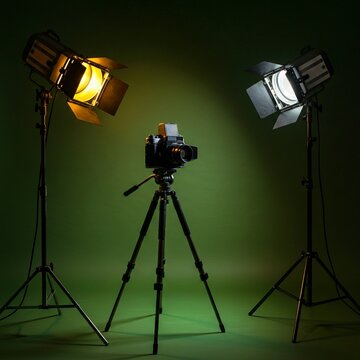 photo studio equipment, Cartoon vintage film camera on tripod under spotlight. Cinema symbol with popcorn, filmstrip, clapper board. Retro entertainment object for motion picture, television, media pr