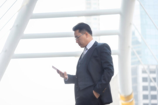 Businessman using smart phone communication him work. People partner man check data financial in tablet computer. Business and Technology Concept.
