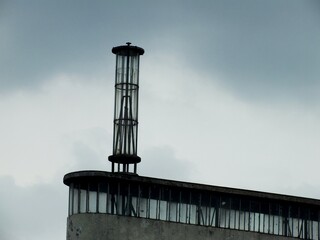 A dramatic cityscape with dark, stormy clouds casting dramatic moody scene. 
Dark clouds cover the sky before rain, climate change awareness campaign