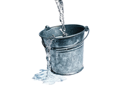A galvanized metal bucket, slightly weathered, receives a stream of water pouring into it. Water spills from the bucket's lip