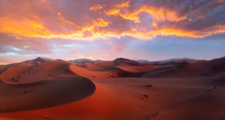 Sand dunes in the Sahara Desert at amazing sunrise, Merzouga, Morocco - Orange dunes in the desert...
