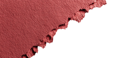 Close-up of a textured, deep rose-red cosmetic product, with a jagged, uneven edge, against a black background