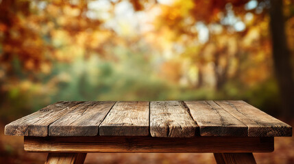 Naklejka premium Rustic wooden table in autumn forest with colorful leaves, creating warm and inviting atmosphere