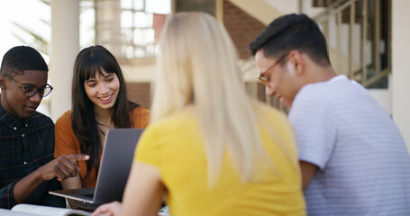 Laptop, teamwork and people in library with studying for college exam, test or assignment together. Computer, happy and students with education for assessment with group at university campus.