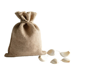 Burlap sack filled with garlic, with one bulb on a white background