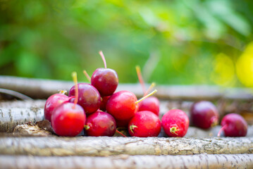 many small red apples lie on a piece of wood. High quality photo