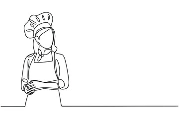 Chef in a toque and apron standing with folded hands