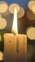 Lit candle with bokeh background