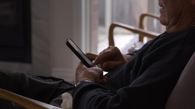 Older retired man using smartphone - tech savvy seniors  - close up on hands